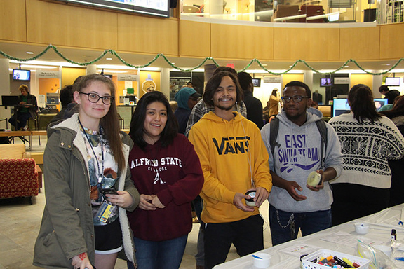 four students in the SLC building