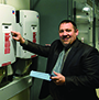 Glenn Brubaker, director of Facilities Operations at Alfred State, takes readings from the 18 kW photovoltaic arrays