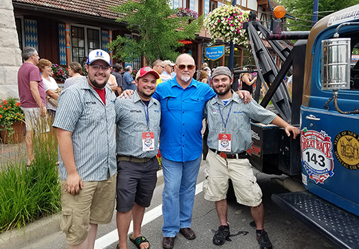 President Sullivan with students next to truck