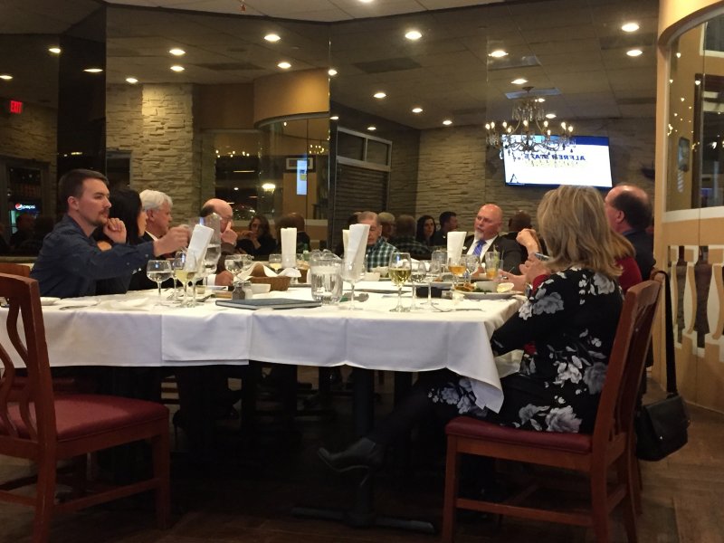 several people sitting at a table in a restaurant
