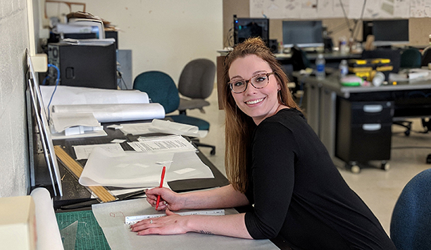 Kacie Matuszak at a table with papers