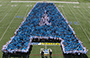 Students, faculty, and staff create a human Alfred State College logo