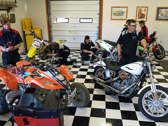 Alfred State students with motorcycles.