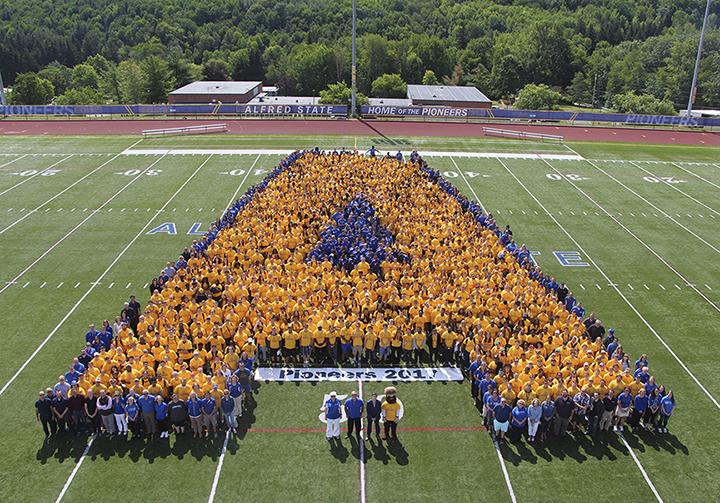 Students, faculty, and staff create a human Alfred State logo