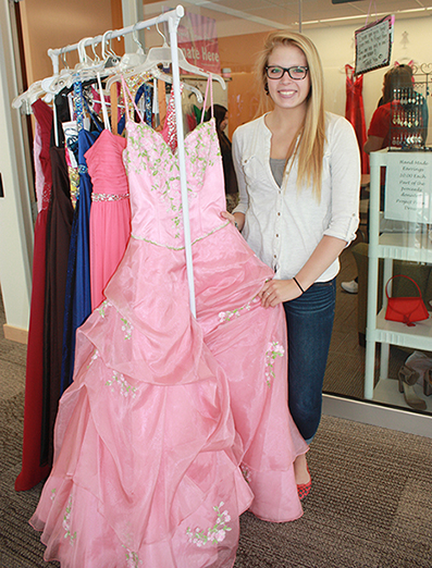 Christine Dodd holding up a prom dress