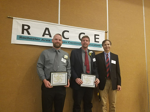 Two of the winners pose with Dr. Robert Curry