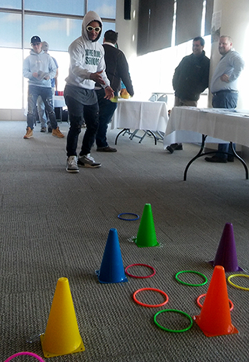 student tossing rings onto colorful cones