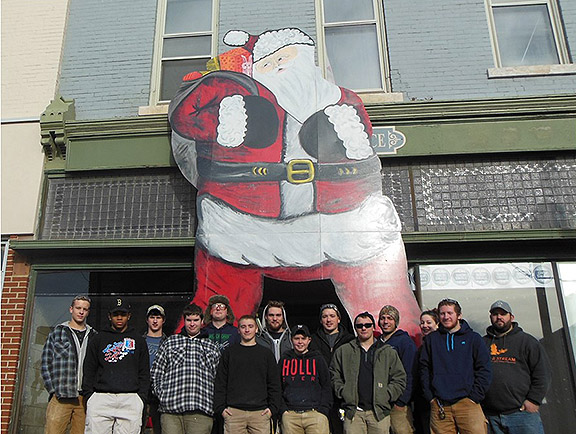 building construction students with Santa that they built