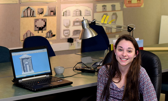 Sarah Travers sitting in front of a computer