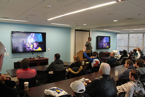 Spencer in front of an audience of students