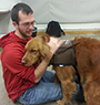 male student with a therapy dog
