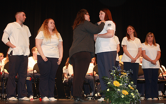 nursing students on stage at their pinning ceremony