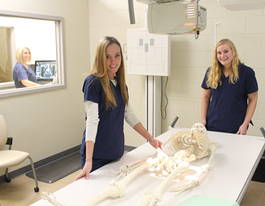 students near a skeleton in a lab
