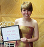 Kaitlyn Cook wearing a prom dress and holding a sign that says 'i said yes to the dress'