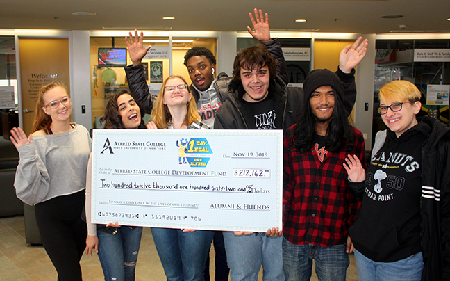 students holding a big check