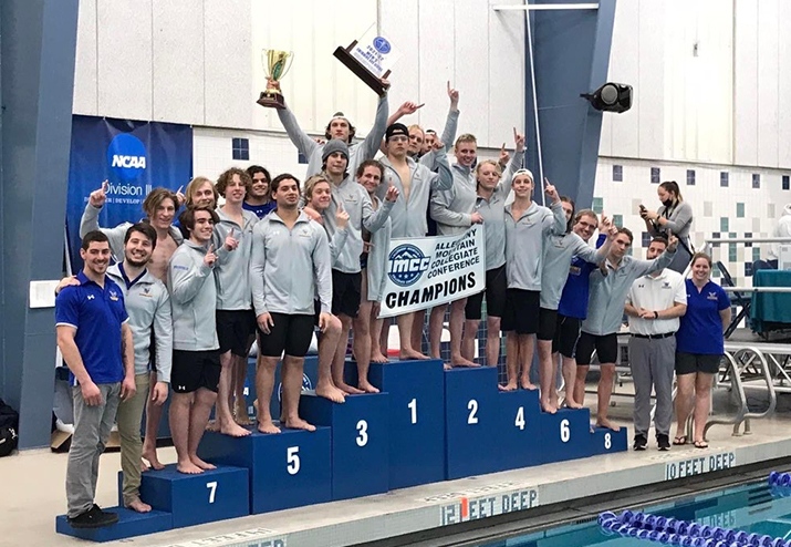 The Alfred State men’s swimming & diving team on the award stand