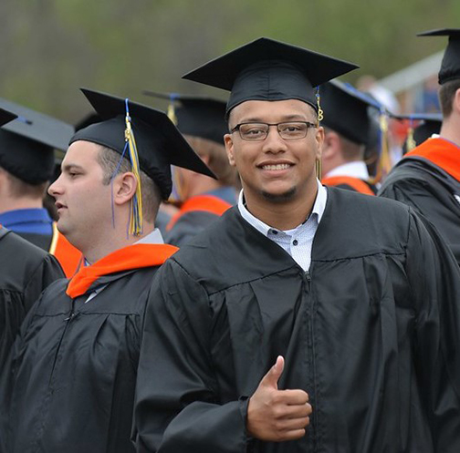 student wearing a commencement cap and gown