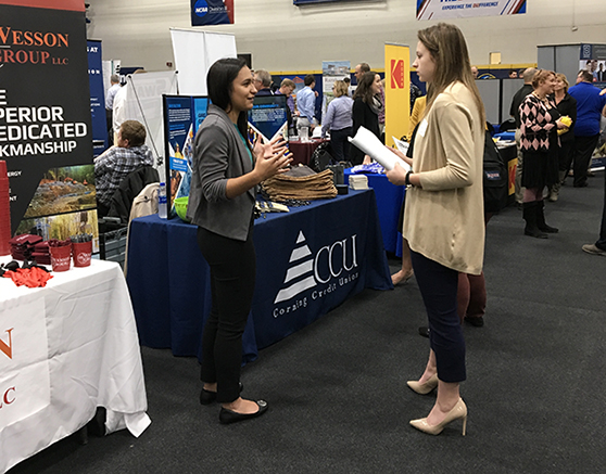 student speaking with an employer at the career fair