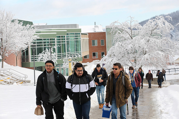 students walking up the center of campus
