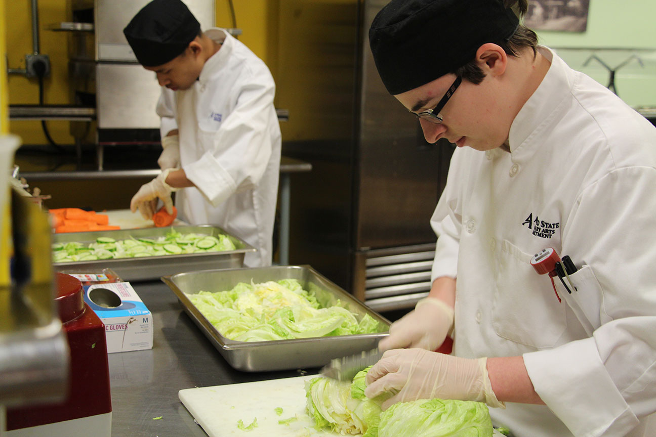 Culinary arts students prepare salads