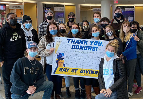 group of students holding a thank you sign