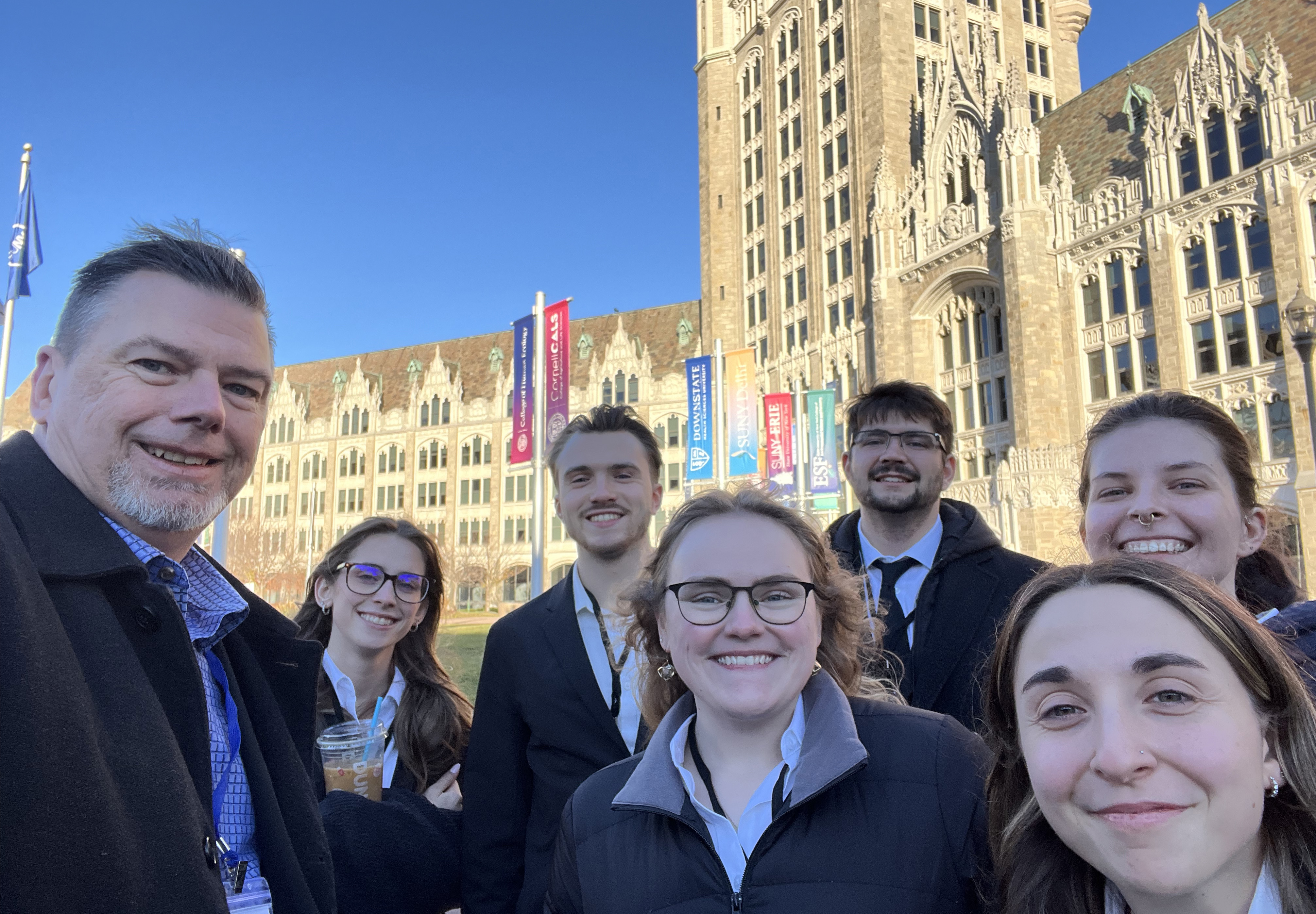 Design-Build team stands in front of SUNY building