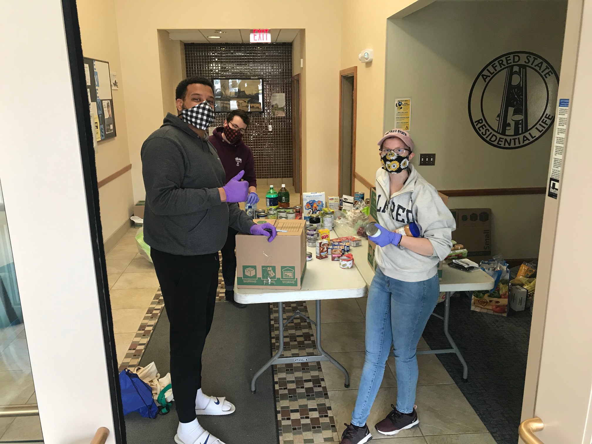 Alfred State staff members help a student through the new pilot food pantry program