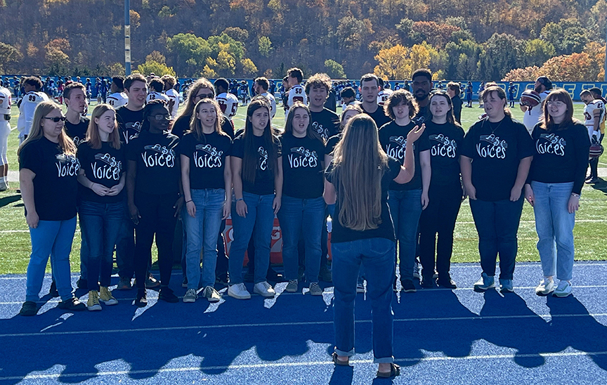 Alfred Voices performs the National Anthem at the football game.