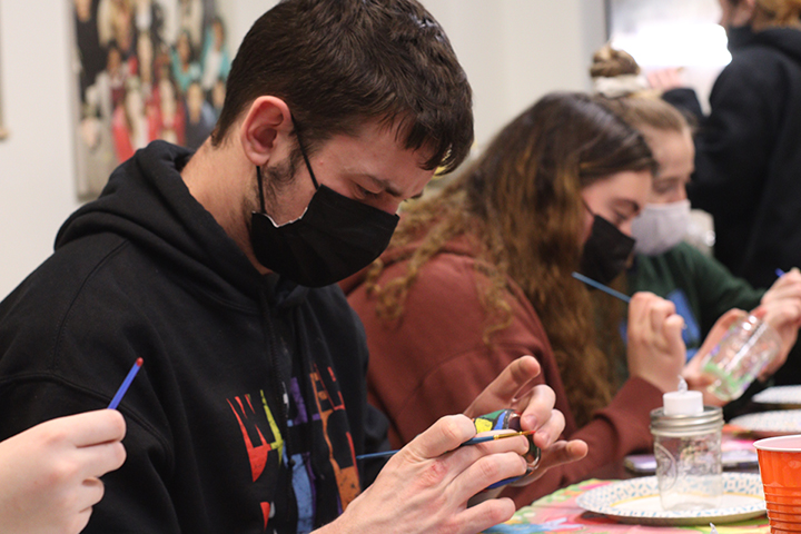 Students paint mason jars during de-stress fest