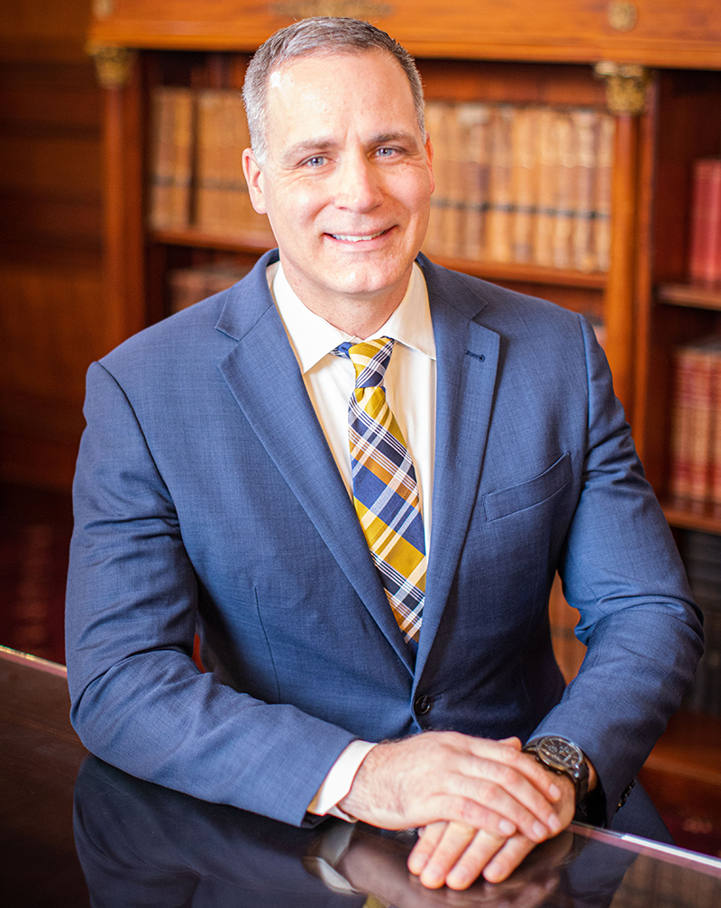 Incoming Alfred State College President Dr. Steven Mauro sitting at a desk