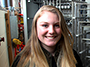 mechanical engineering technology student Allison DeGraff in front of some equipment