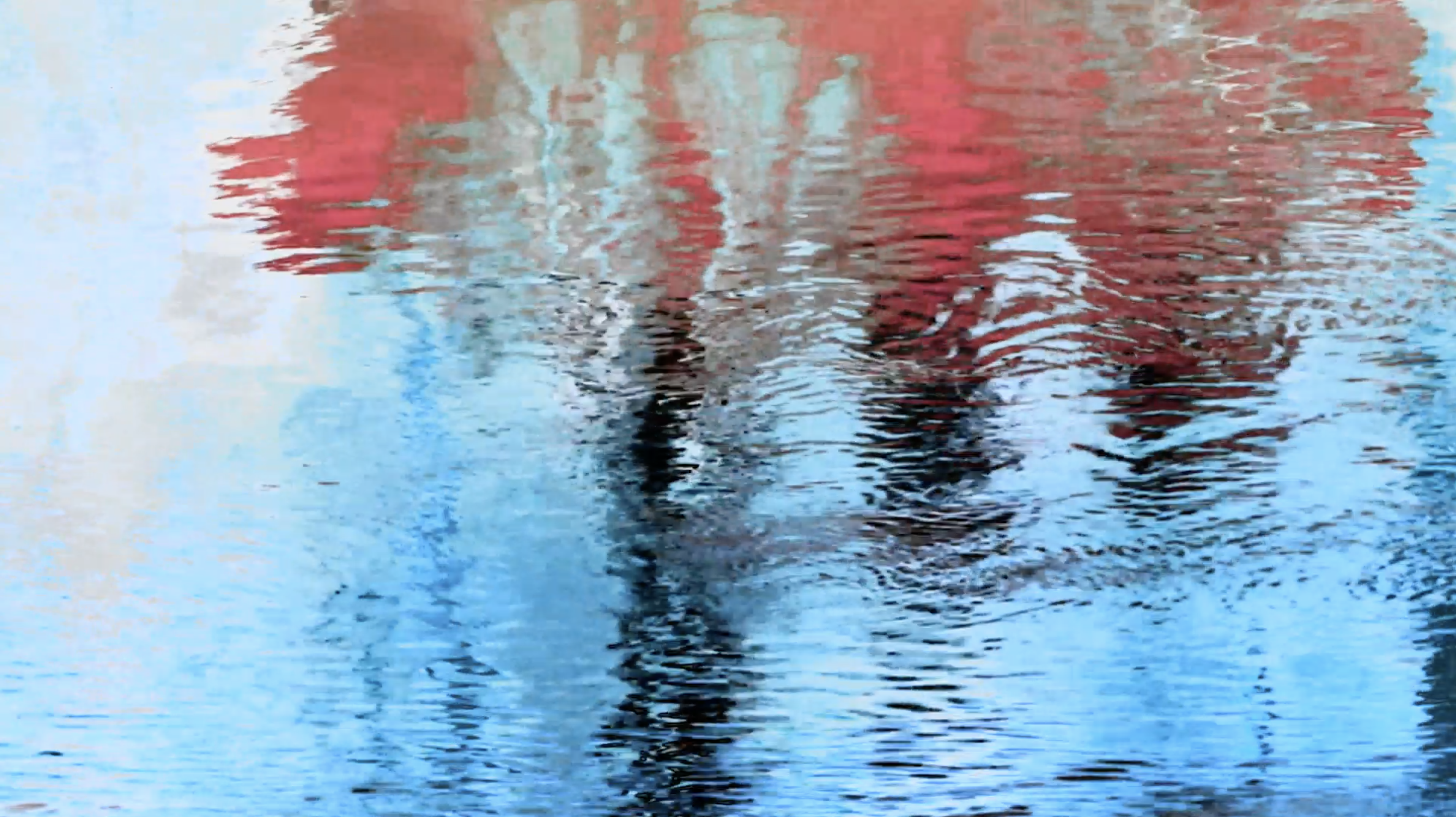 Still image from a work of visual poetry featuring a reflection in water.
