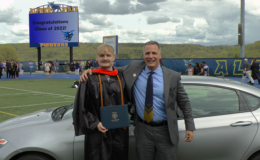 Thomas Nelson poses with his new car and ASC President Dr. Steven Mauro.
