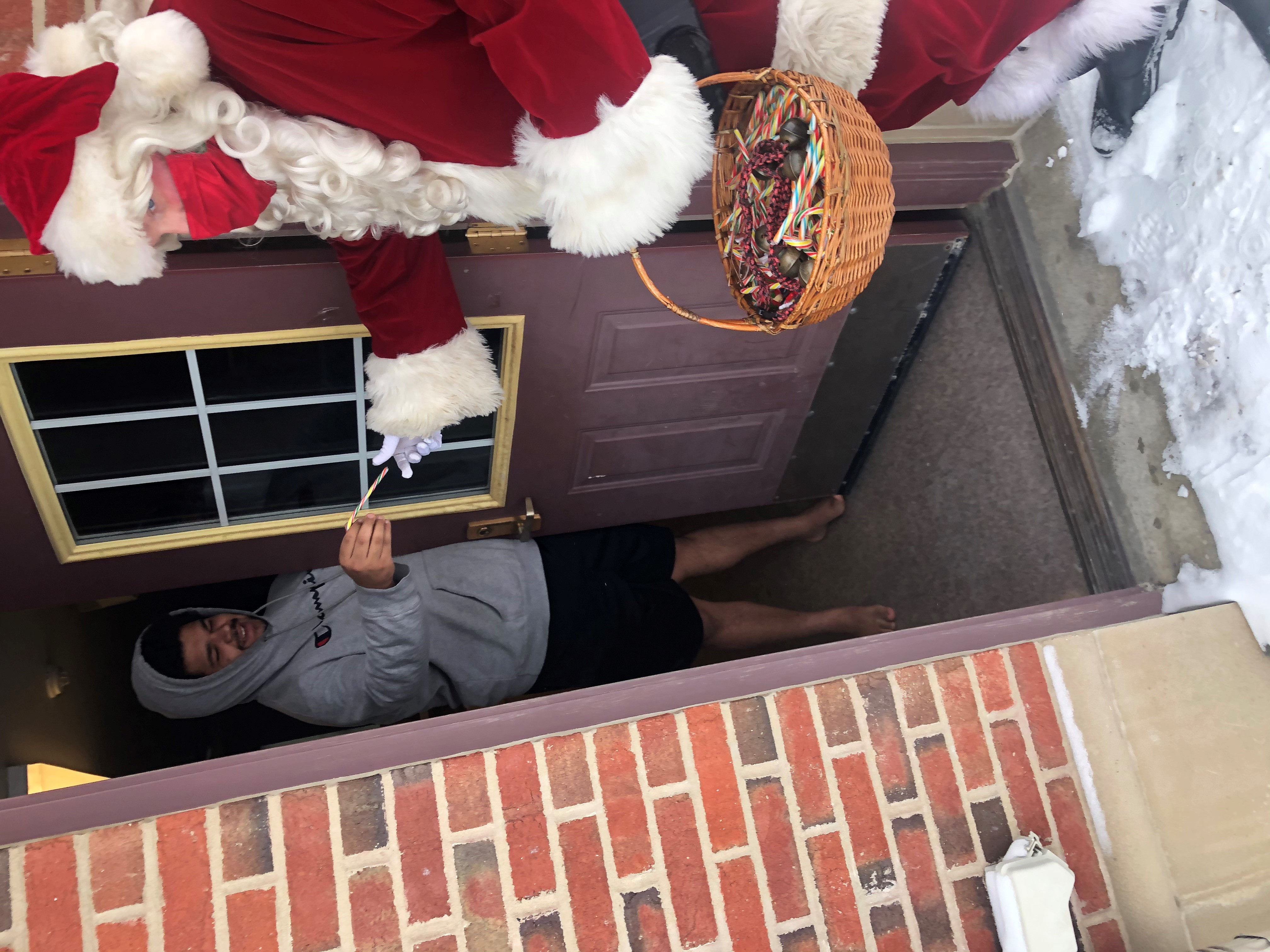 Santa Claus delivers gifts to students