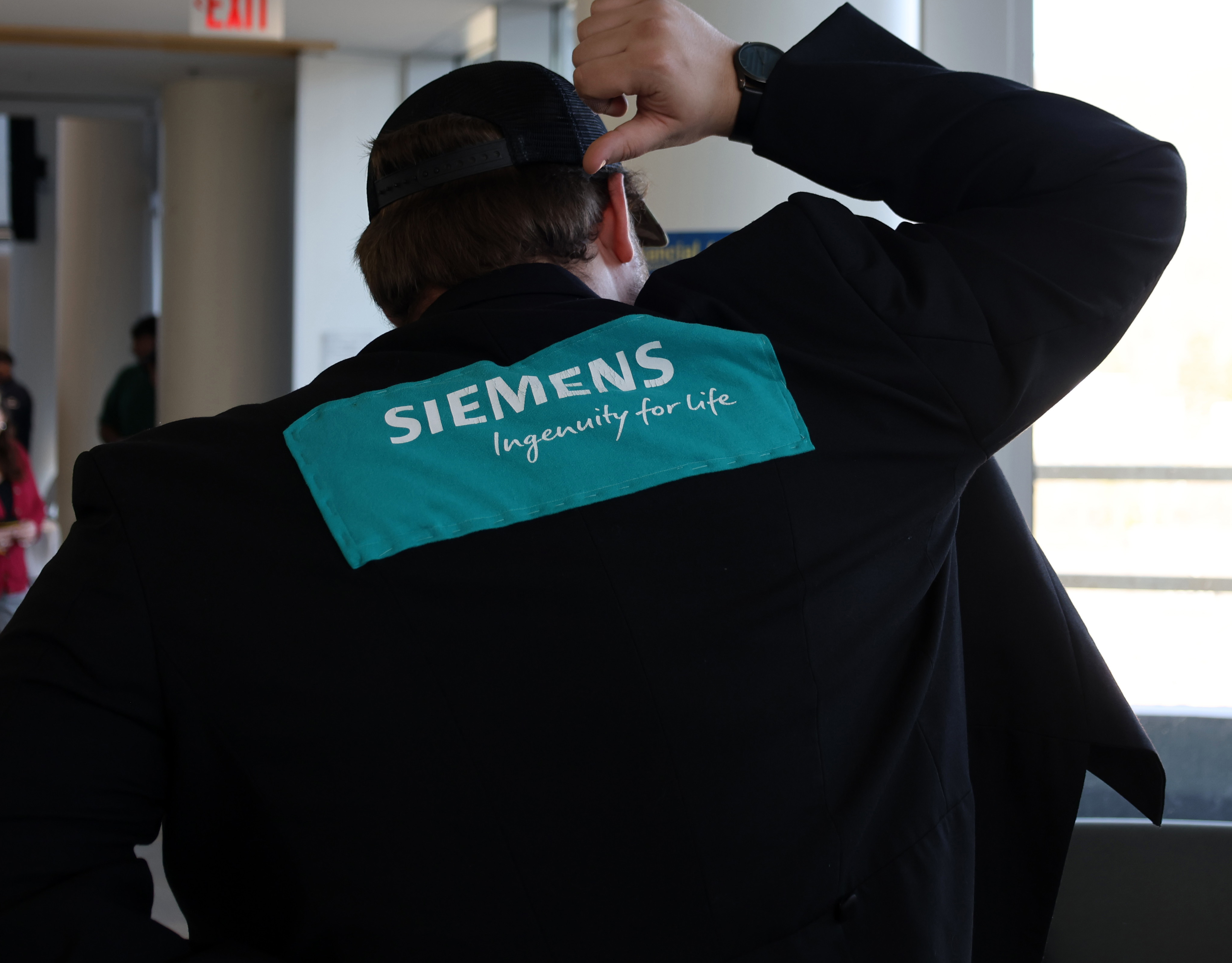 student shows off new jacket at celebration of signing day