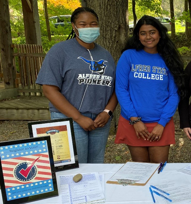 students standing behind a table