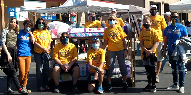 several people wearing yellow and blue t-shirts and face masks