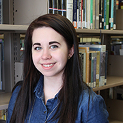 Kyra Hancock in front of book case