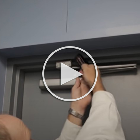 hands putting something in a doorway, play button to YouTube video