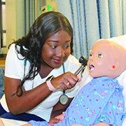 Valerie Davis with doll in a lab