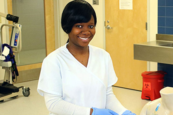 Olufunmilola Olojede in a nursing lab with blue gloves on