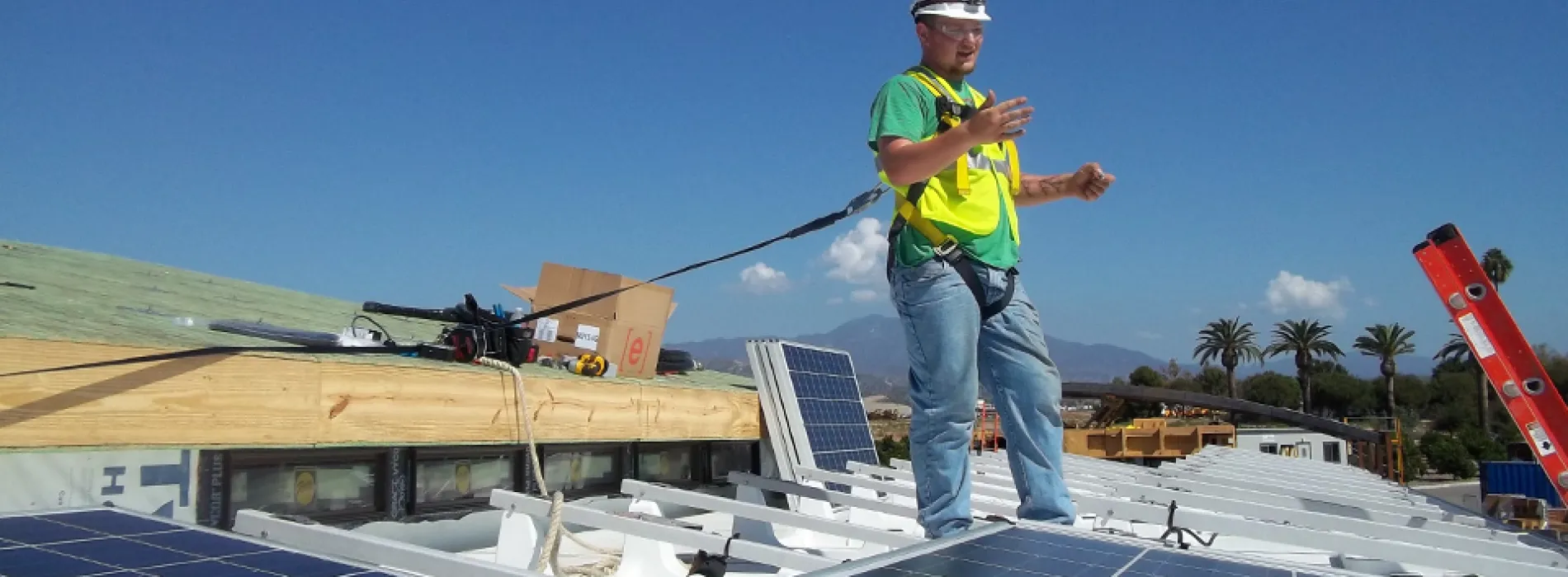 male student installing solar panels