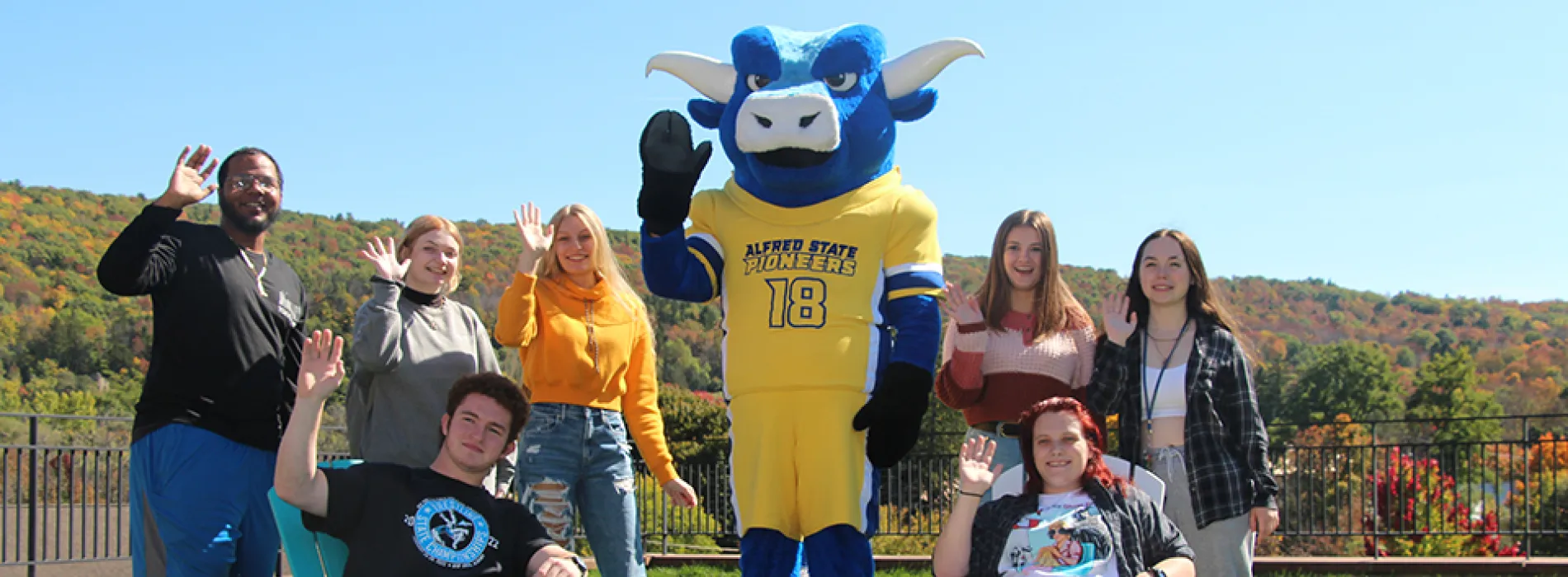 students with the Ox Mascot waving