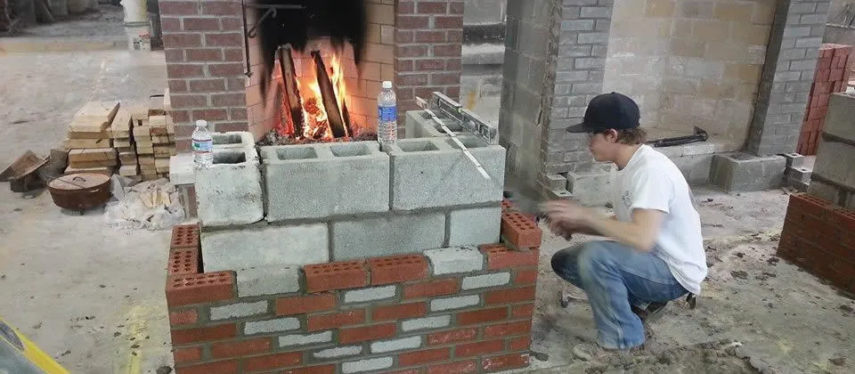 student building a fireplace