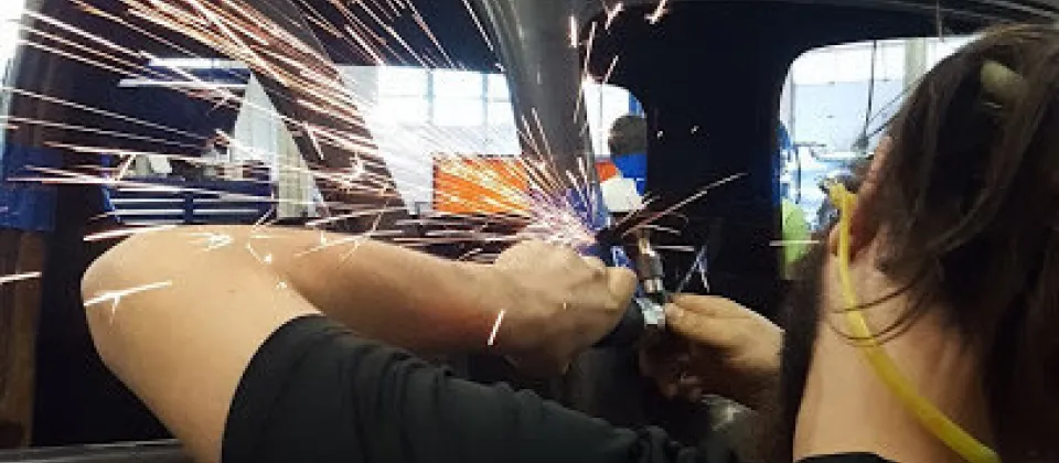 sparks, student working on a vehicle