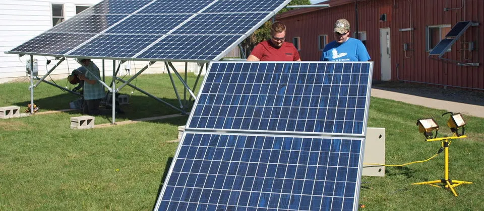 solar panels and two male students