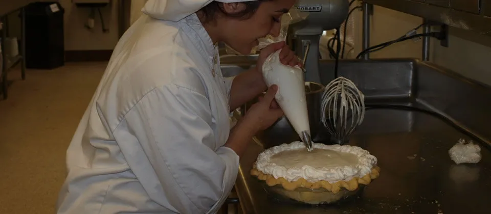 student decorating a pie