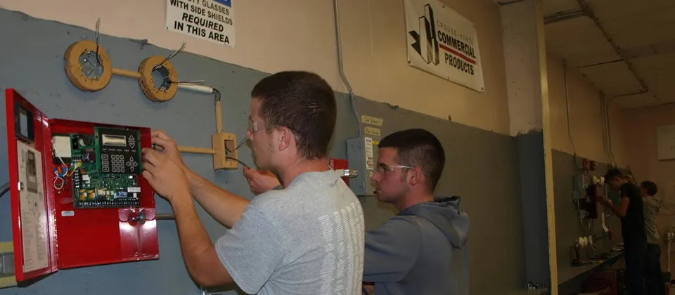 student working on electrical equipment