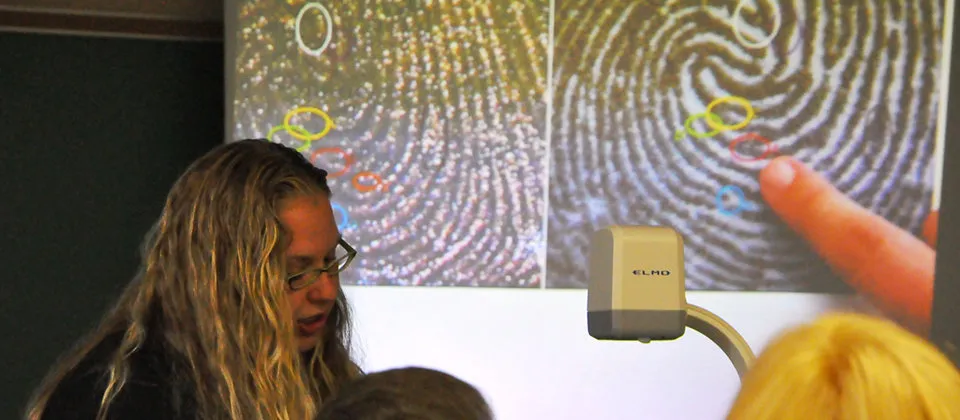 female presenting fingerprints on overhead projector