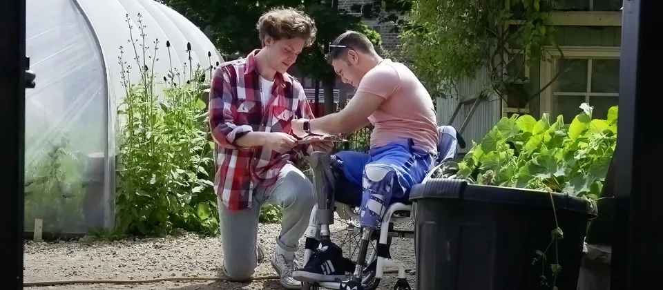 Counselor helping man in wheelchair